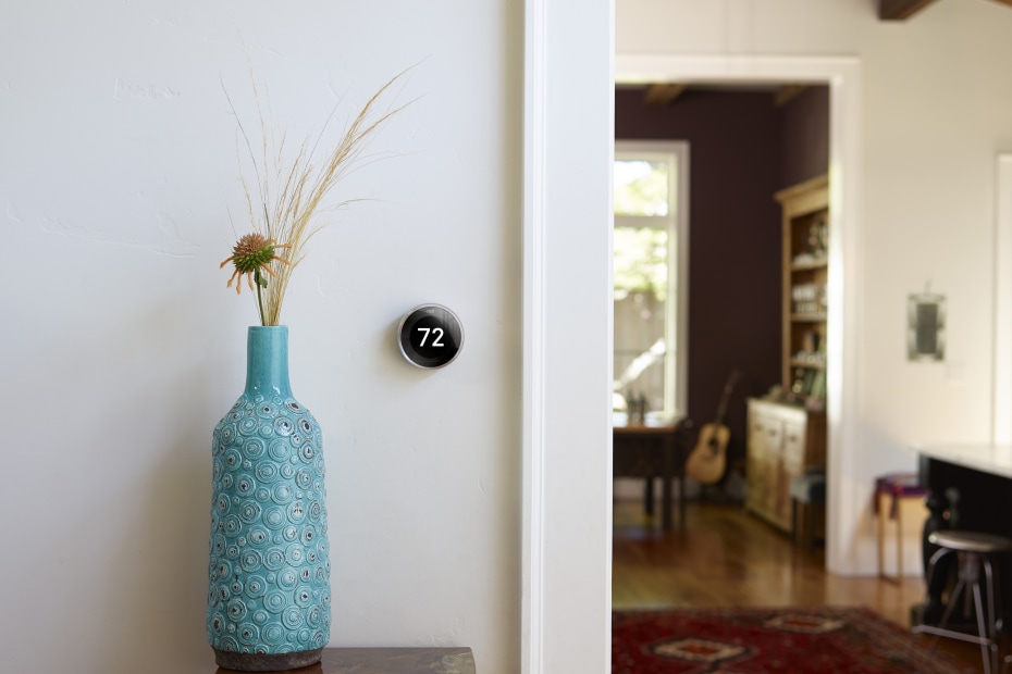Nest thermostat on a living room wall.