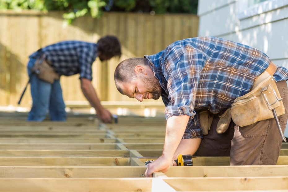 Builders create a wooden deck.