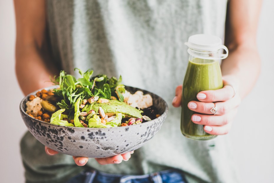 A woman holding a rice bowl and green goddess dressing.