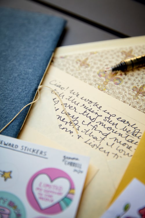 hand-written letter with pen, stickers, and scrapbook material