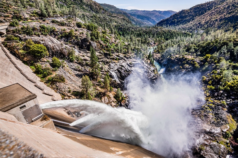 arcing jets of runoff pour from O'Shaughnessy Dam in the Hetchy Hetchy Valley at Yosemite National Park