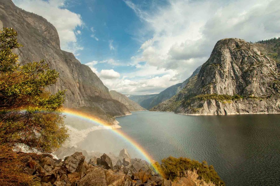 panorama of Hetch Hetchy Reservoir with arcing rainbow along the trail to Wapama Falls in Yosemite National Park