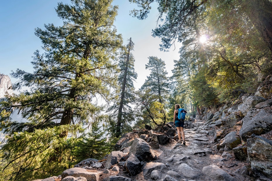 solo hiker pauses to take in the view from the John Muir Trail in Yosemite National Park