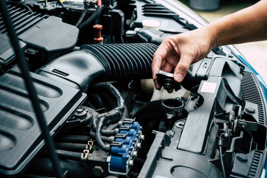 AAA Member checks their car's radiator fluid.