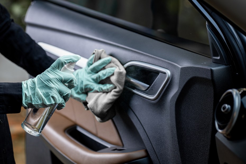 AAA Member cleans car door handle.