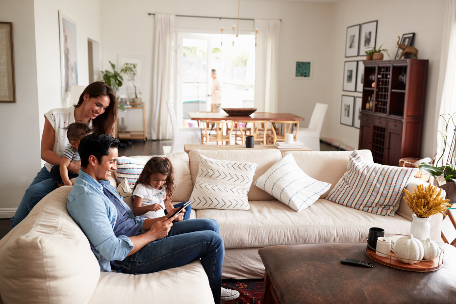 Family relaxes together on the living room couch.