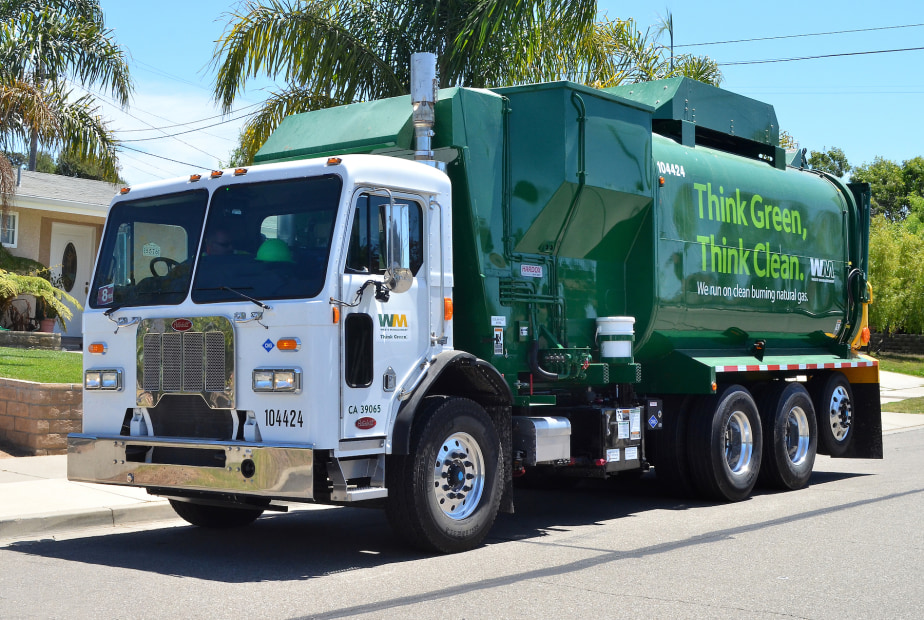 Image of a green Waste Management trash collection truck