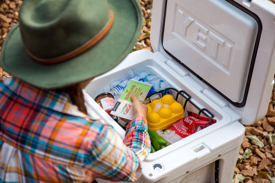 Megan McDuffie removing food from a Yeti cooler.