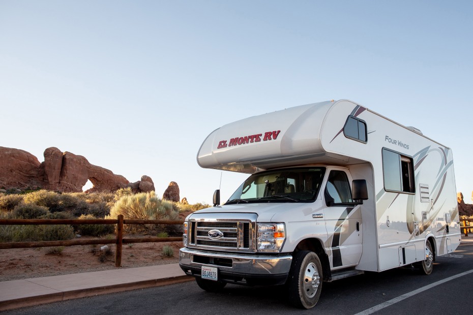 RV parked in front of a red rock formation in the U.S.