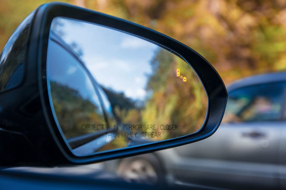side view mirror with reflection in traffic