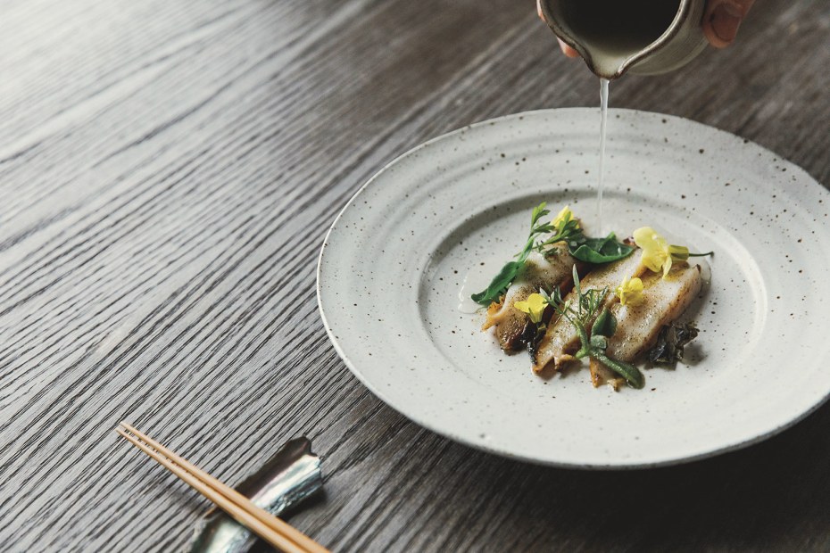 grilled abalone with coastal succulents being drizzled at table with fermented field mustard broth at Harbor House Inn, Elk, California