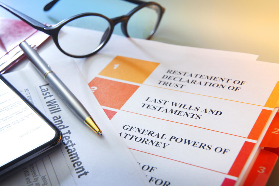 paperwork, pen, and glasses sitting on a desk