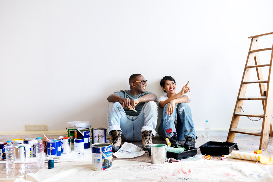 A couple prepare to paint a white room.