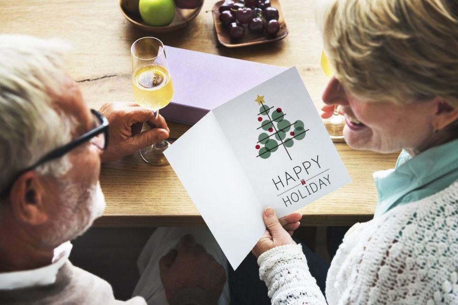Grandparents open a holiday card together.