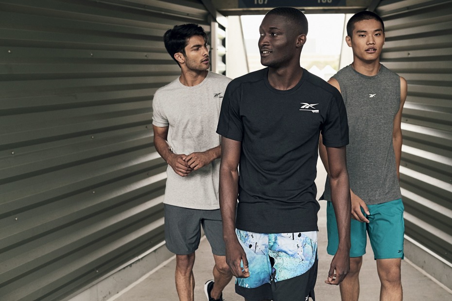 Three young men modeling Reebok athletic gear