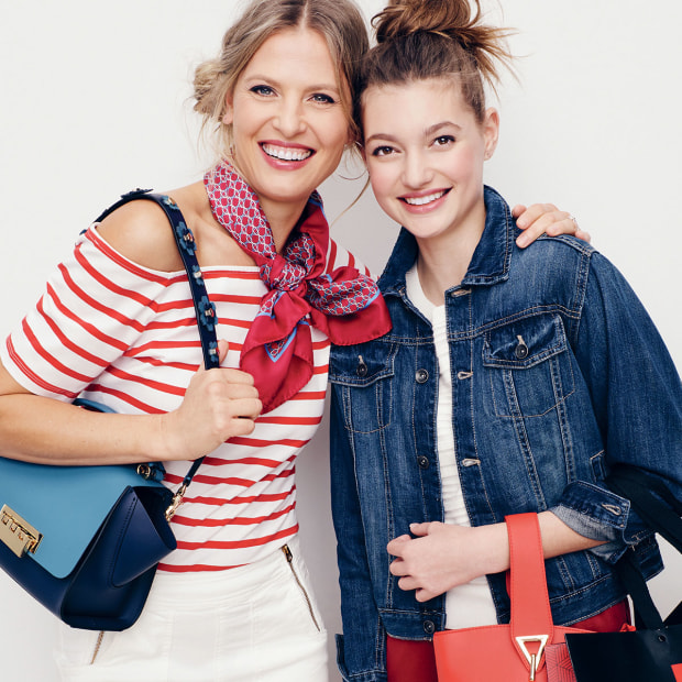 Young women model clothing, bags, and accessories for Tanger Outlets