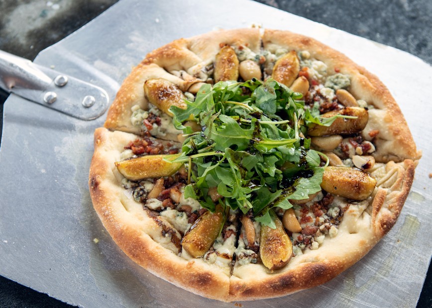 Figgy Piggy Pizza of roasted garlic, gorgonzola, figs, bacon, arugula microgreens and balsamic vinegar is a feature at The Nest in Ojai, Calif.