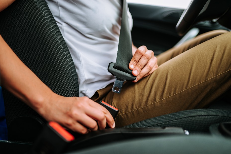 a driver buckles their seat belt.