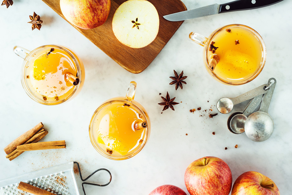 Spiced apple cider on a countertop with star anise.
