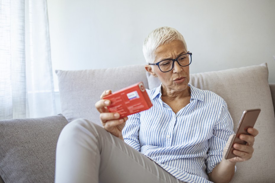 A woman looks up a medication.