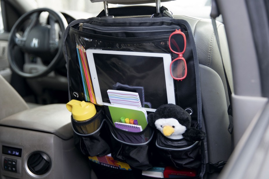 A rear-seal organizer hangs off the passenger seat with kid's toys in the pockets.