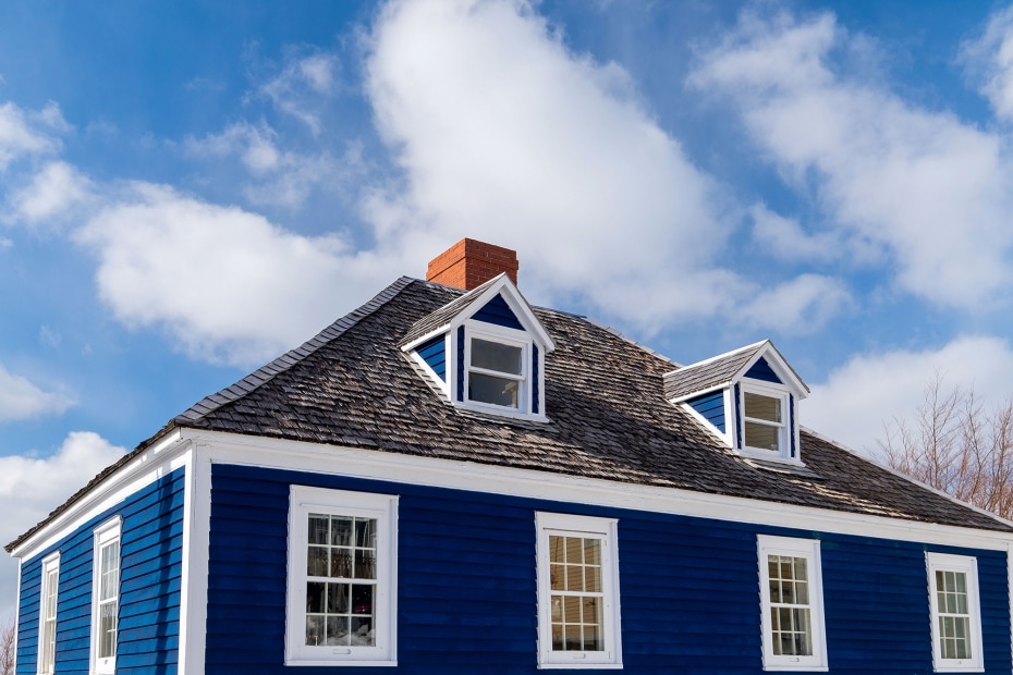 A blue home against a blue sky.