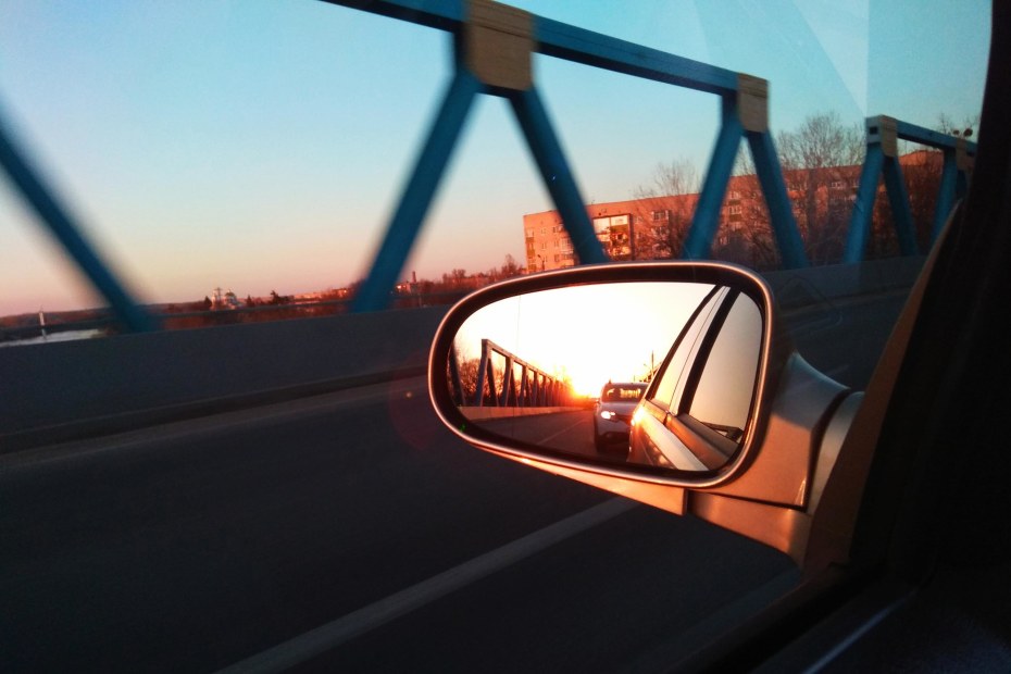 A car visible in a driver's side mirror.
