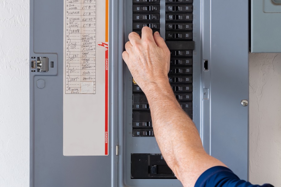 A home buyer tests the electrical breaker.