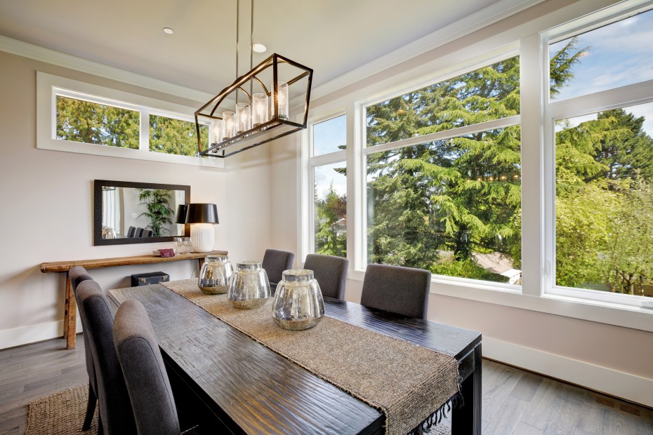 Staged dining room with big windows.