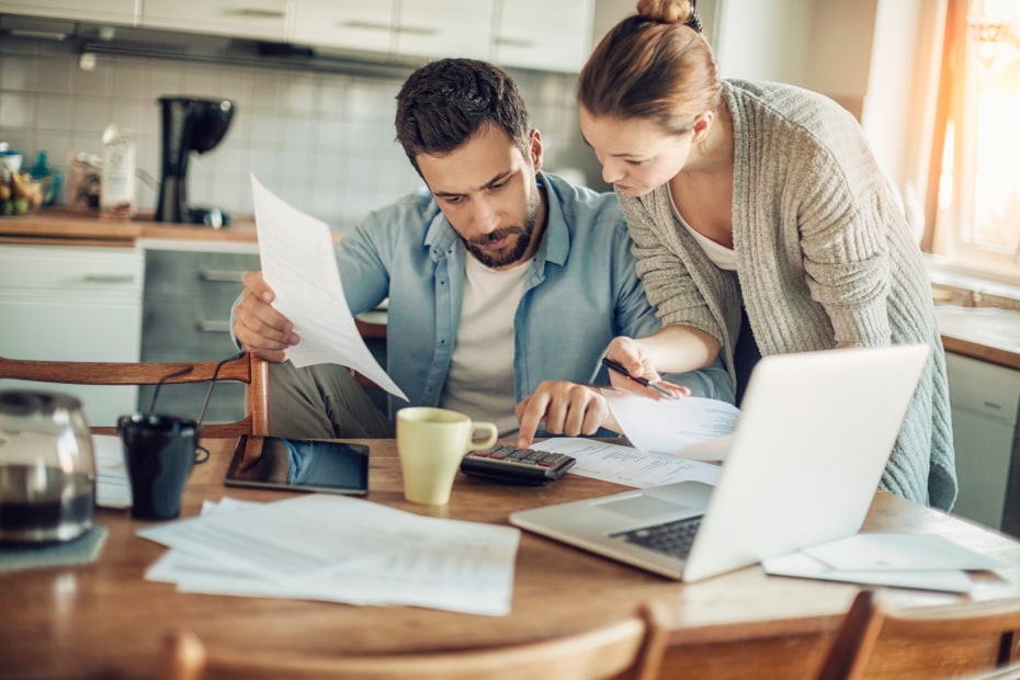 A couple review their finances on a computer.