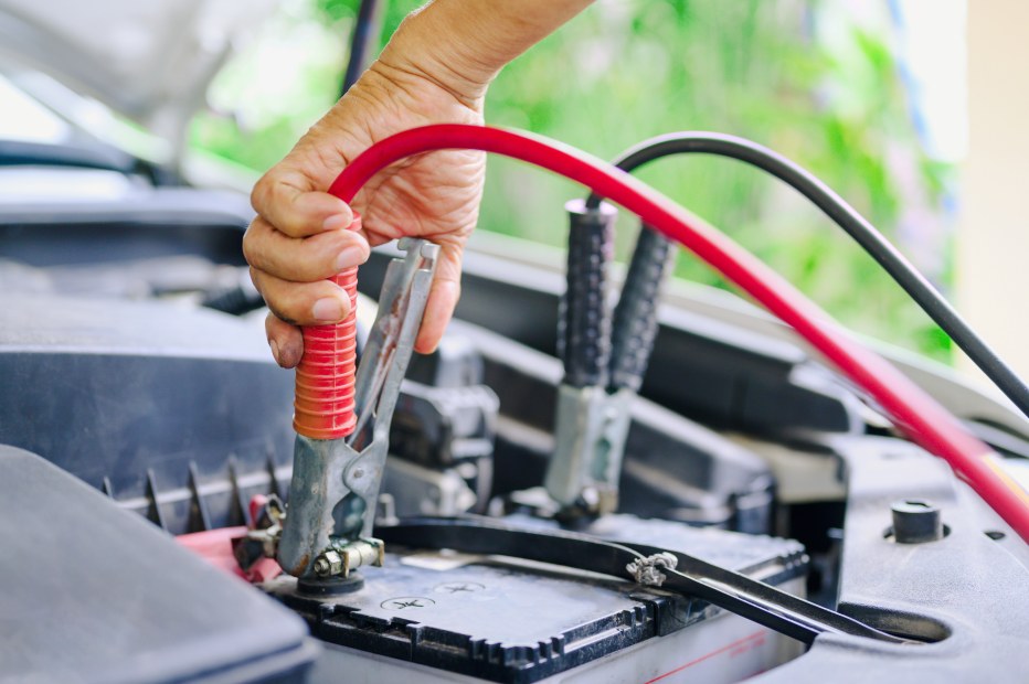 Jumper cables attached to the car battery.