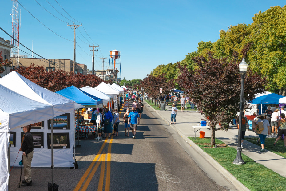 People browse booths at Idaho Falls Farmers Market on Memorial Drive.