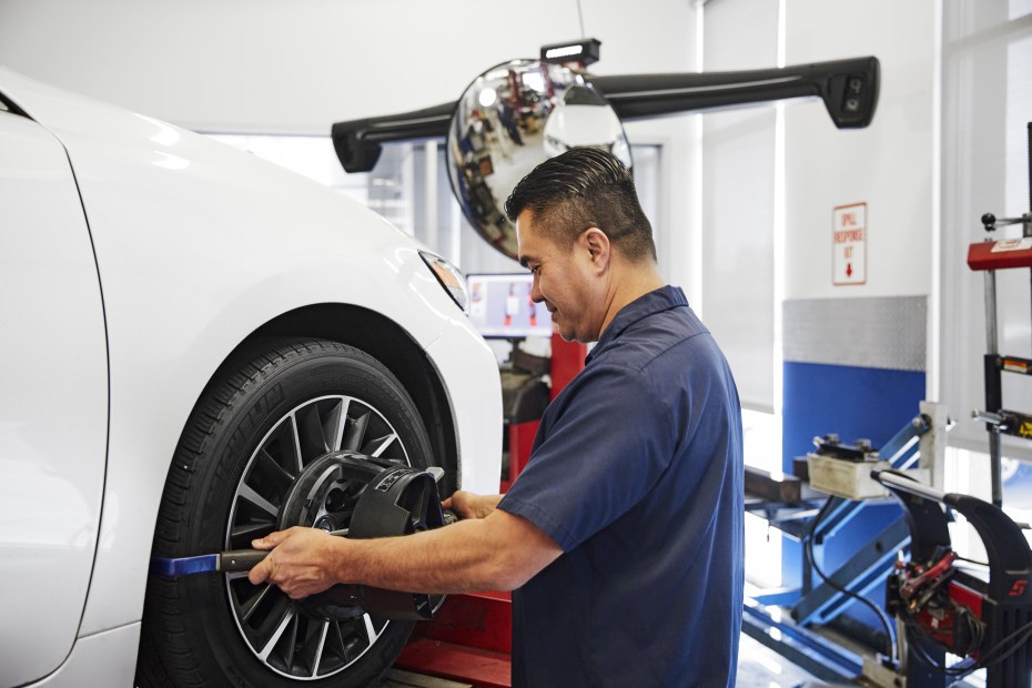 A mechanic performs a wheel alignment at AAA Car Care Plus in San Jose.  