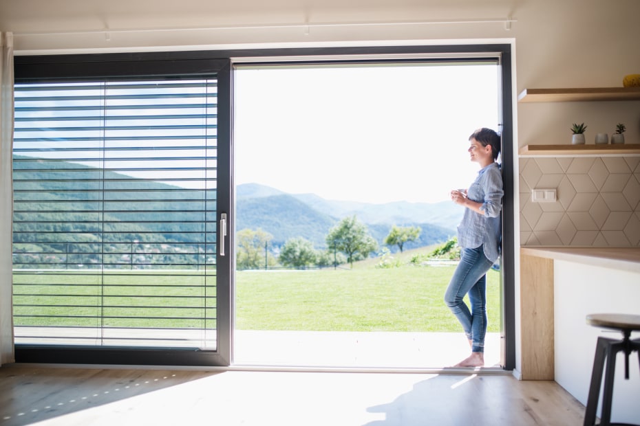 A woman stands in an open sliding door.