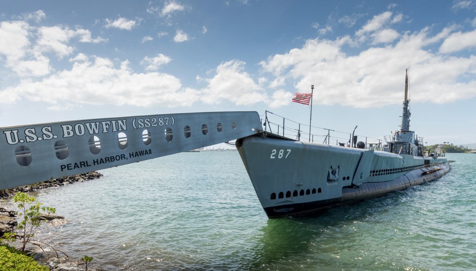 The WWII USS Bowfin submarine in the water at Pearl harbor.