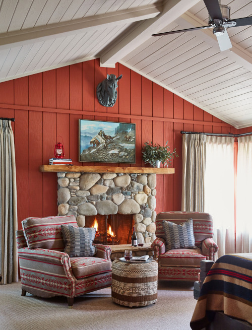 Two lounge chairs in front of a fireplace in suite at The Alisal Guest Ranch & Resort.