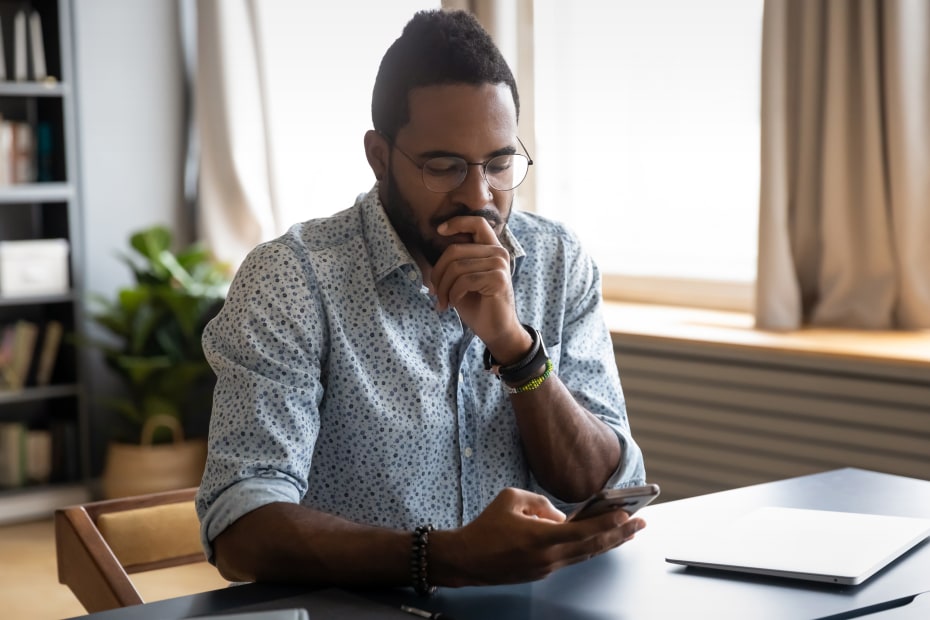 A man reads a scam text message.