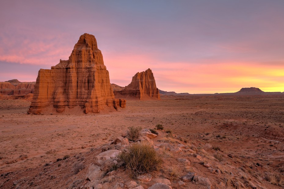 The sun sets beyond Temple of the Moon and Sun in Capitol Reef National Park.