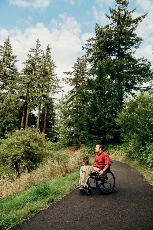 A hiker in wheelchair descends the Hoyt Overlook Trail  in Portland's Hoyt Arboretum.