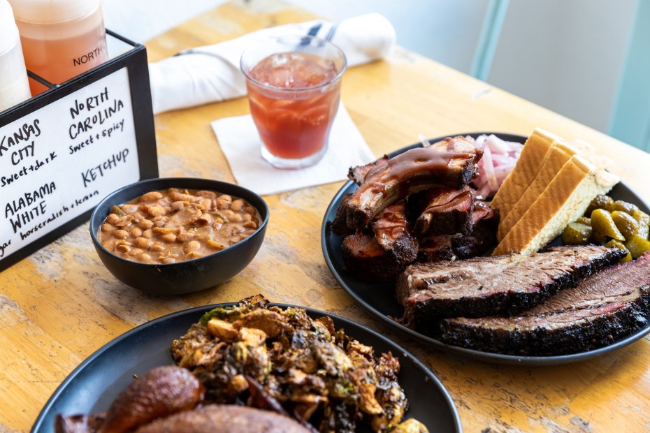Brisket, ribs, and baked beans on the table at Smoke Point BBQ & Provisions.