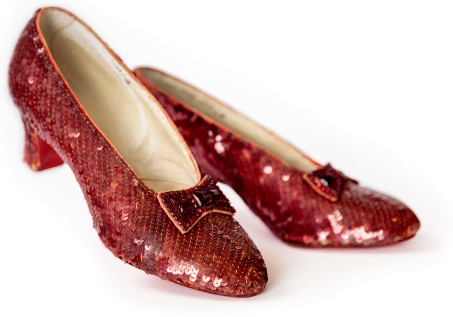 Wizard of Oz ruby slippers on a white background.