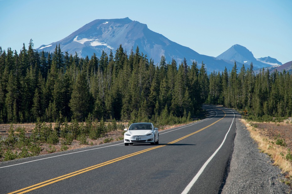 A Tesla drives on Cascade Lakes Highway near South Sister and Bend, Oregon.