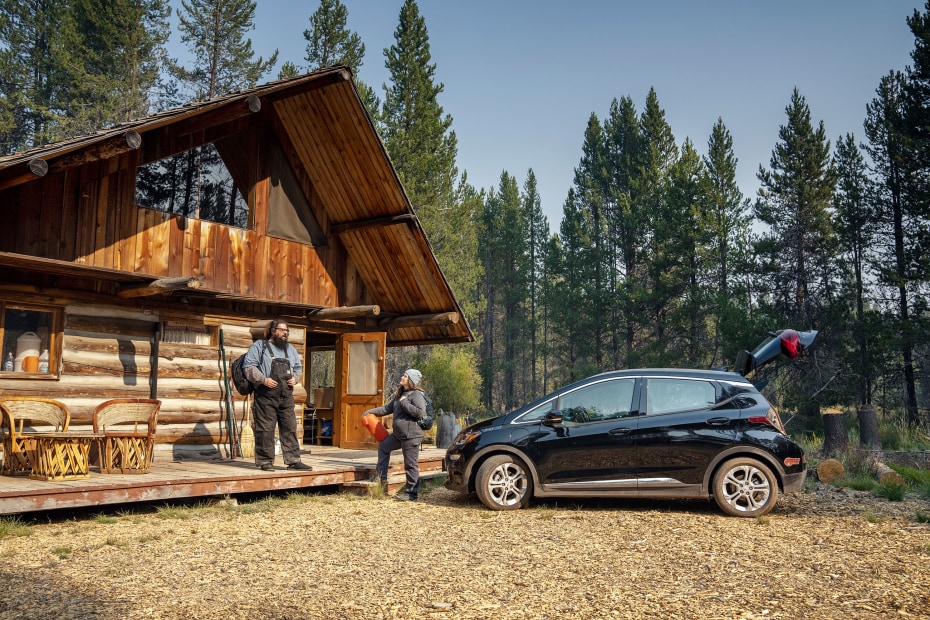 Erich Wise and Leah Laird unload their Chevy Bolt outside their cabin.