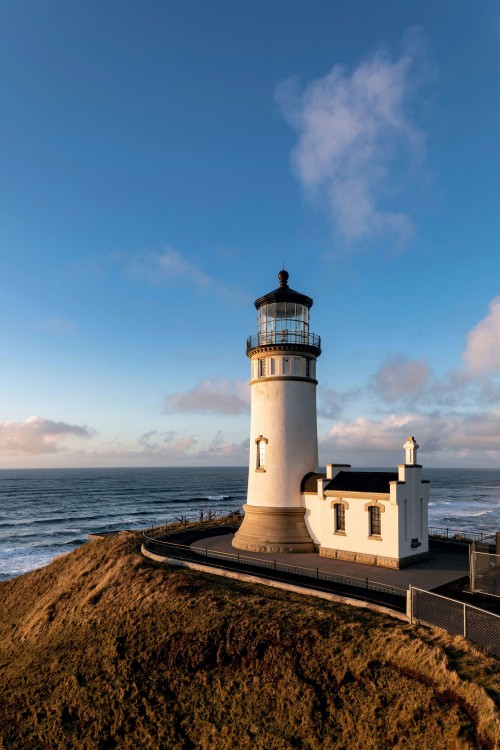 North Head Lighthouse in Cape Disappointment State Park on a blue day.