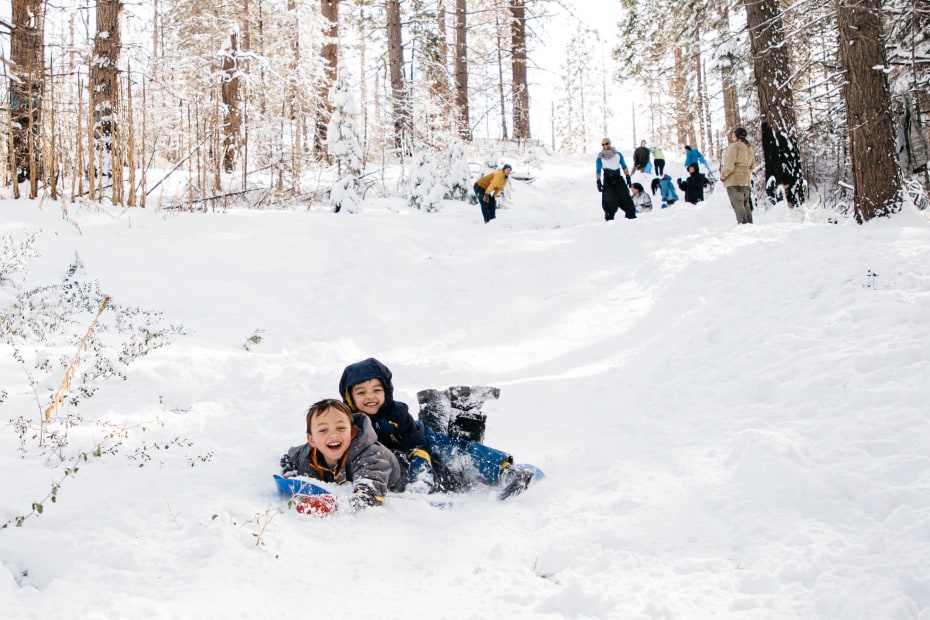 Kids sled down the hill at Tenaya Lodge in Yosemite National Park.