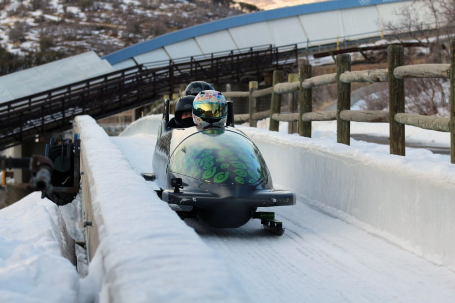 A driver takes two riders down the Olympic bobsled run at Utah Olympic Park.