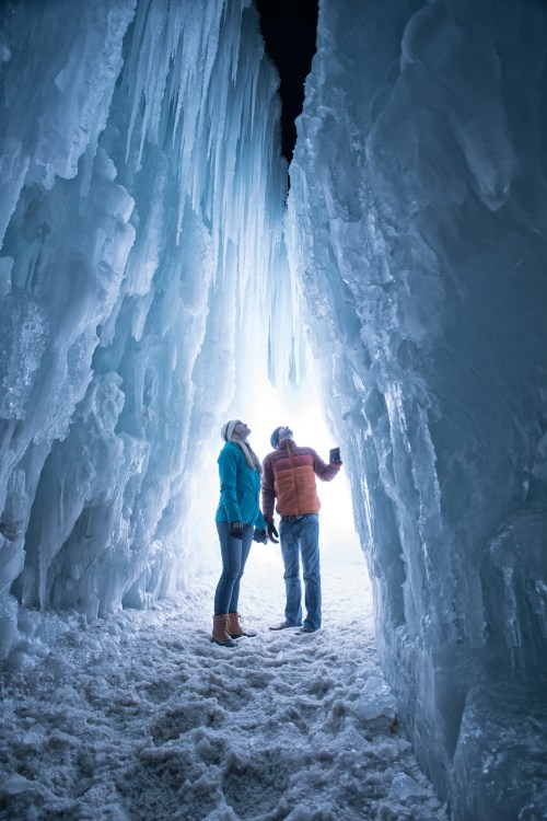 A couple stand inside an Ice Castle in Midway, Utah.