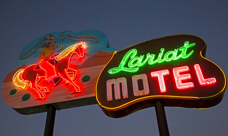 Neon sign lit up at night outside the Lariat Motel in Fallon, Nevada.