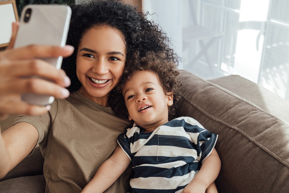 A mom takes a selfie with her young son.