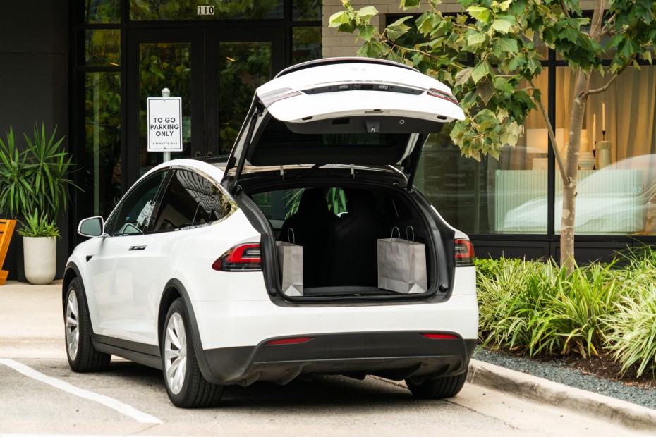 A Tesla Model X with the trunk open.